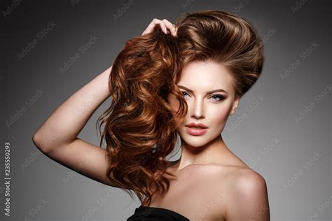 Beauty Fashion Model With Long Shiny Hair Waves And Curls Volume