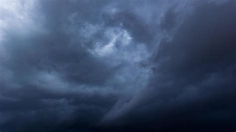 The Dark Sky With Heavy Clouds Converging And A Violent Storm Before