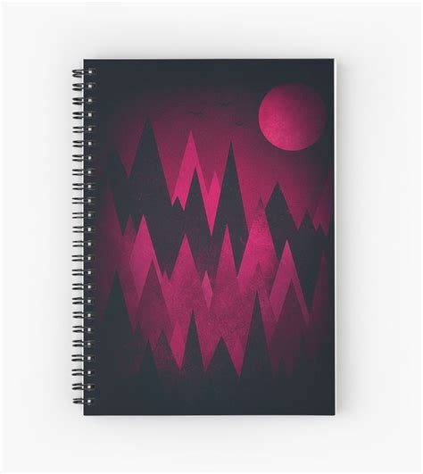 A Spiral Notebook With Mountains And A Red Moon In The Background