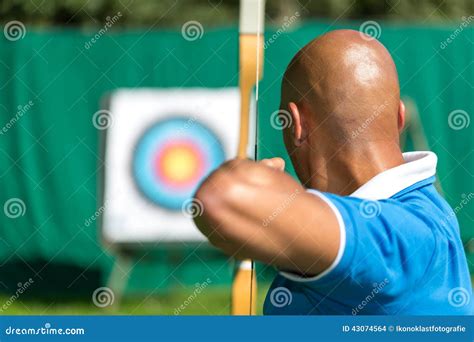 Archer Aiming At Target With Bow And Arrow Stock Photo Image Of Focus