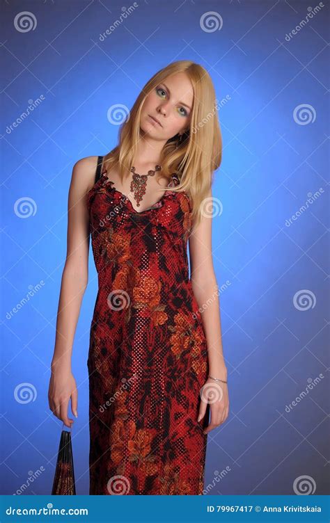 Blonde In A Red Dress On A Blue Background Stock Image Image Of Dress