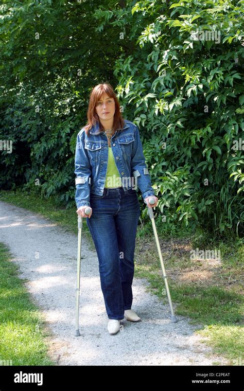 Woman Walk On Crutches In Park Stock Photo 36144272 Alamy