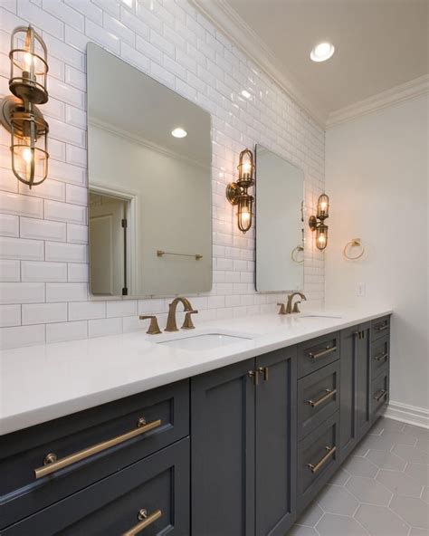 Maybe you would like to learn more about one of these? dark cabinets, gold hardware, subway tile bathroom ...