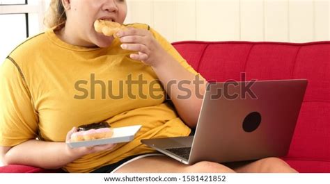 Chubby Woman Eating Donuts Surfing Internet Stock Photo Edit Now