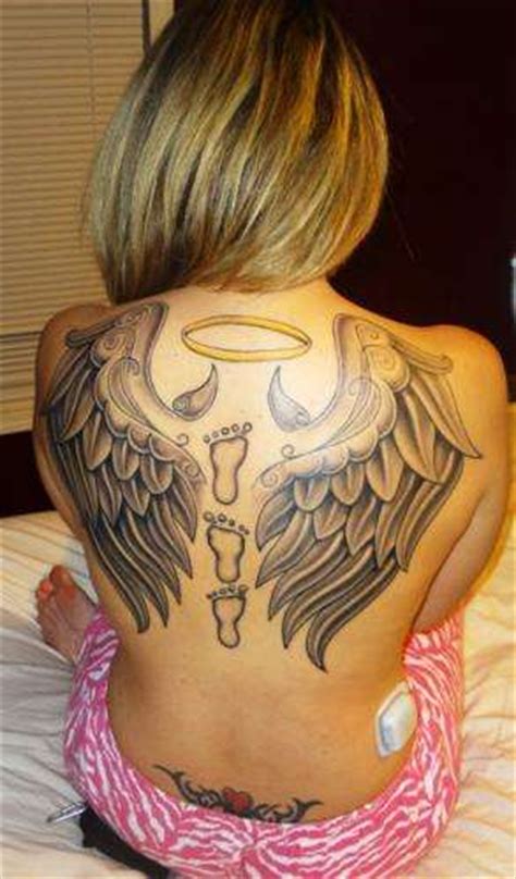 Devil horns tattoo on men forehead. angel wings with horns holding halo tattoo