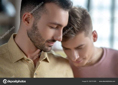 Two Men Standing Next To Each Other Feeling In Love Stock Photo By