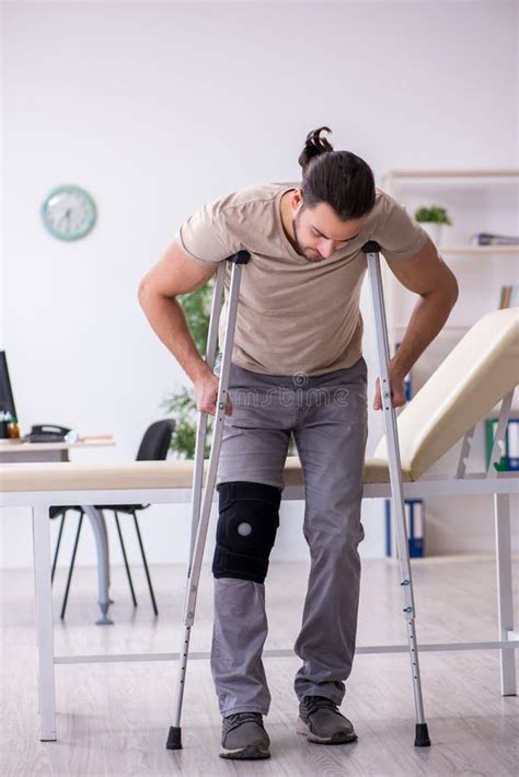 Young Leg Injured Man With Crutches Stock Image Image Of Bone Injury