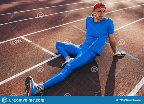 Relaxed Caucasian Athlete Male Doing Stretching Exercises Sitting On