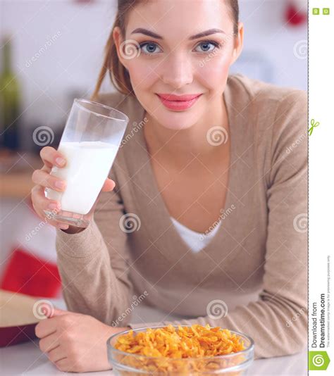 Smiling Attractive Woman Having Breakfast In Kitchen Interior Stock