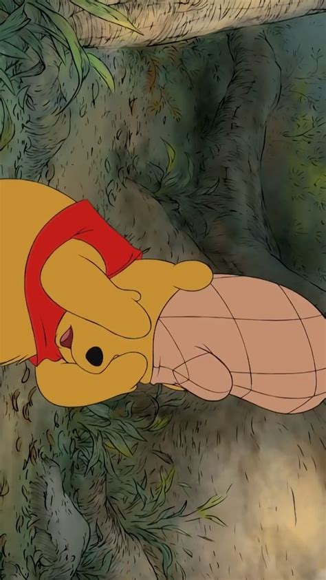 Winnie The Pooh Is Laying Down With Her Head On Top Of A Stuffed Animal