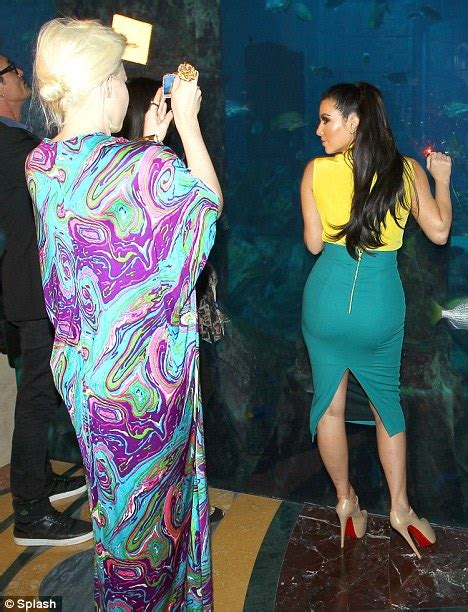 Kim Kardashian Cant Help Showing Off Her Famous Rear As She Poses For