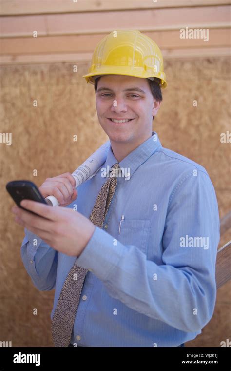 Portrait Of A Happy Caucasian Male Architect Using Cell Phone With