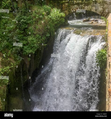 Waterfall Under A Stone Arch Stock Photo Alamy