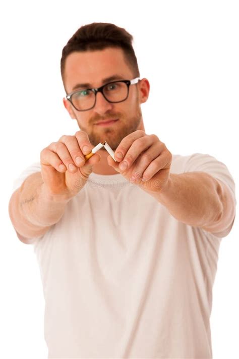 Man Breaking Cigarette As A Gesture Of Quitting Smoking Stock Photo