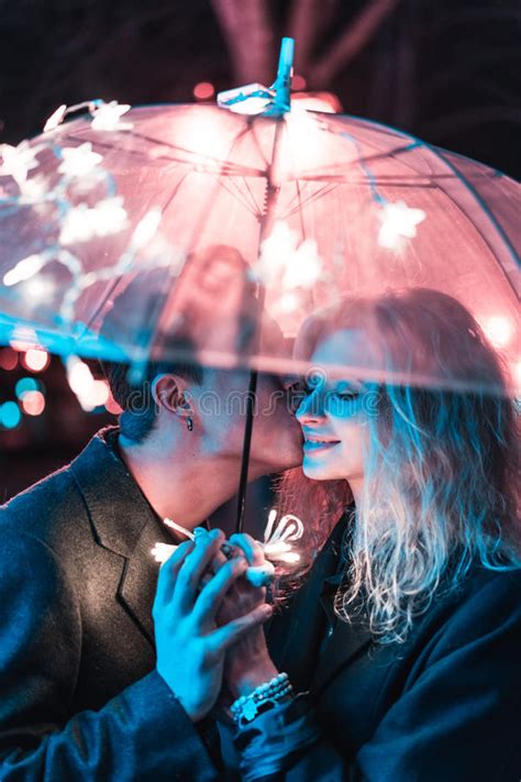 Guy And Girl Kissing Under An Umbrella Stock Image Image Of