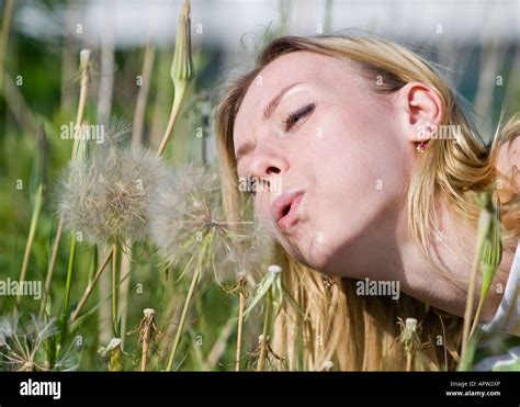 Woman Blowing Dandelion Stock Photo Alamy