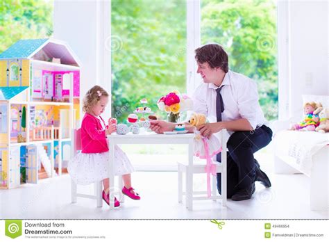 Padre E Hija Que Juegan La Fiesta Del Té De La Muñeca Foto