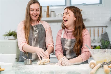 Mother And Daughter Enjoy Baking Bakery Together In The Kitchen Smiling And Laughing Prepare