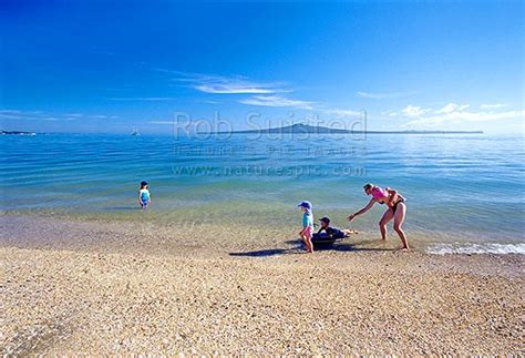 Rangitoto Island Behind Children Swimming At Mission Bay Beach Mission