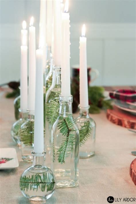 A Table Topped With Lots Of Glass Bottles Filled With Candles