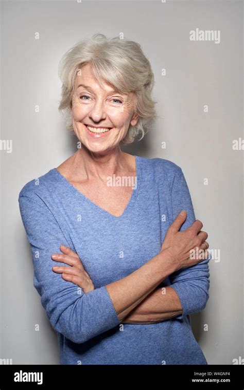 Portrait Of Smiling Mature Woman Wearing Blue Pullover Stock Photo Alamy