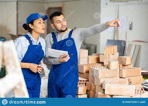 Builders Determining Scope Of Work In Building Under Renovation Stock