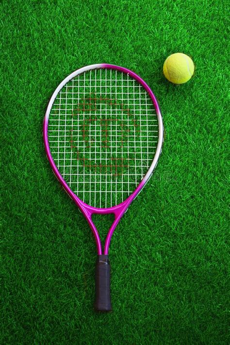 Dual Colour Tennis Racket And Ball On Resting On Grass Editorial Stock