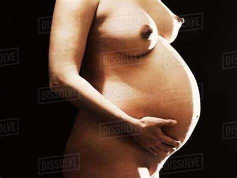 Nude Pregnant Woman Holding Her Belly Stock Photo Dissolve