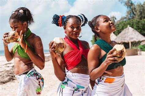 Kenyan People With Coconut At The Beach With Typical Local Clothes