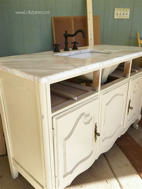 We want a bathroom vanity that'll get the job done and look good doing it—one that's as attractive and chic as it is utilitarian. vintage dresser to bathroom vanity - Lolly Jane