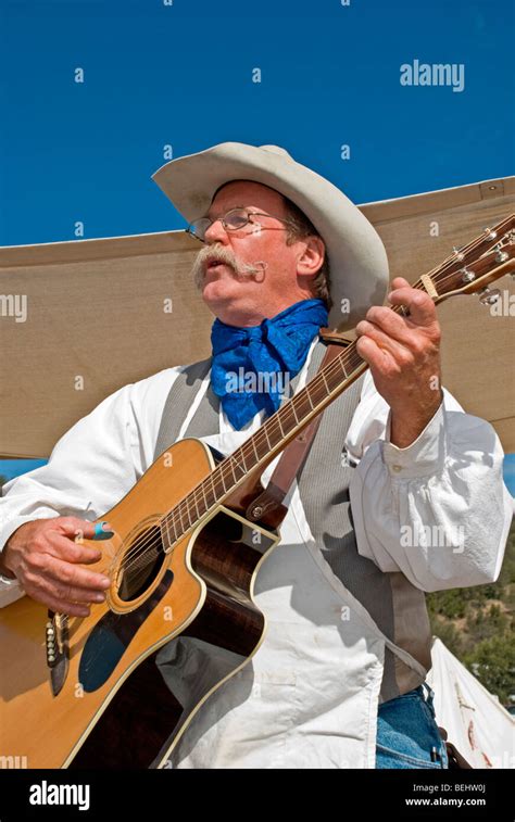 A Country Western Singer Plays Popular Old Western Tunes On His Guitar