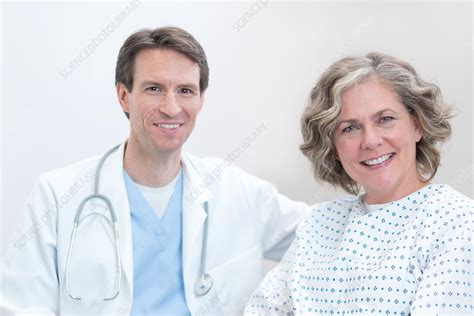 doctor and female patient smiling towards camera stock image f018 2548 science photo library
