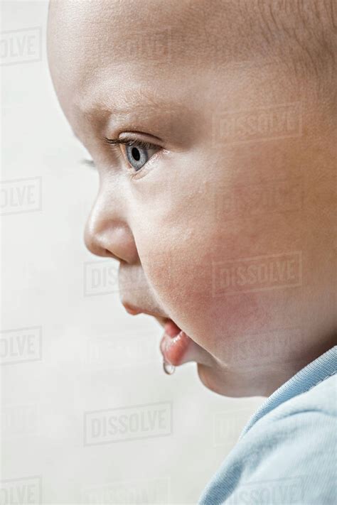 A Baby Staring Off Camera And Drooling Stock Photo Dissolve