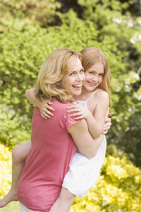 Mother Carrying Daughter Outdoors Smiling Park Outside Cuddling Photo Background And Picture For
