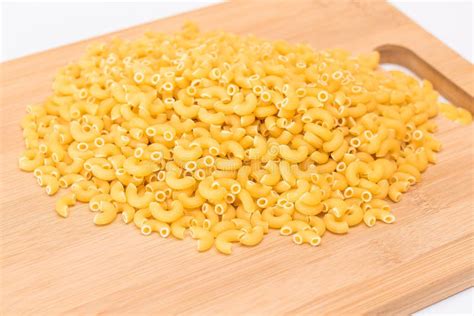 A Heap Of Uncooked Chifferi Rigati Pasta On Wooden Kitchen Board Stock