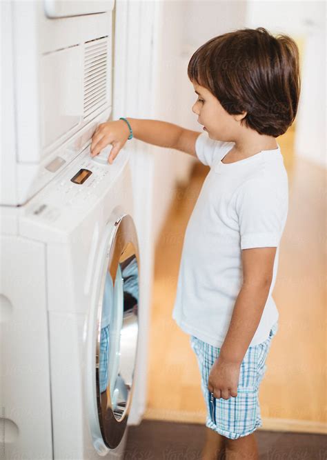 Year Old Boy In Front Of A Washing Machine By Stocksy Contributor