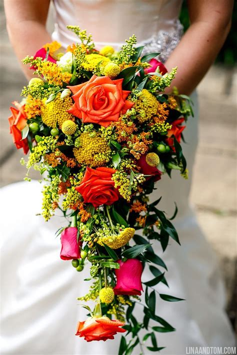 Check spelling or type a new query. A cascading bridal bouquet of orange, pink and red roses ...