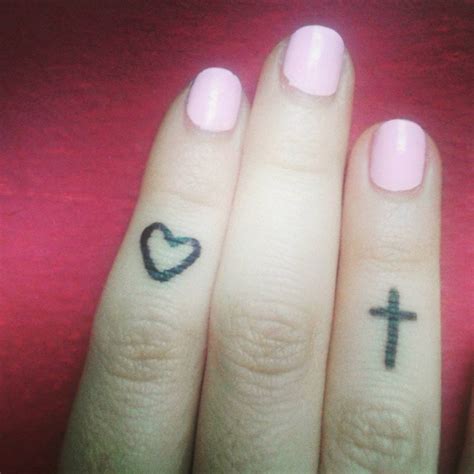 Finger Tattoos Of A Heart And A Christian Cross
