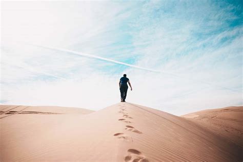 Desert Man Walking On Desert Dune Image Free Photo