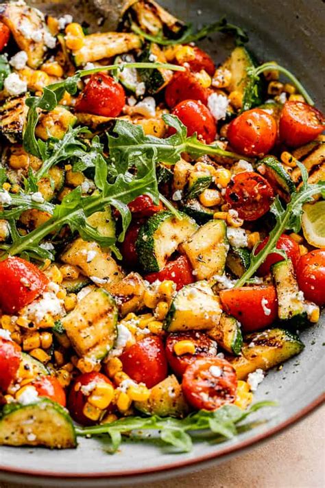 I love zucchini in almost any shape or form. Grilled Zucchini Salad with Corn & Tomatoes - Cravings Happen