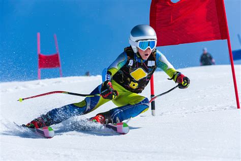 Young Male Skier Passing The Red Gate Giant Slalom Race Stock Photo