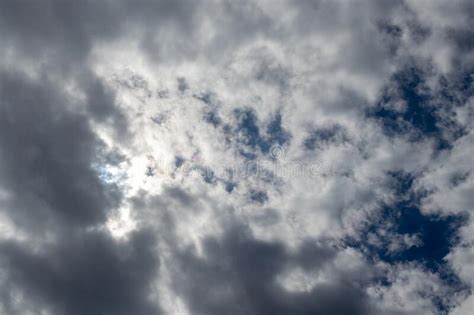 Cloudy Sky With Patches Of Blue And The Sun Hidden Behind The Clouds