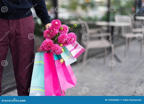 Boyfriend Waiting For His Girlfriend Near Cafe And Holding Flowers