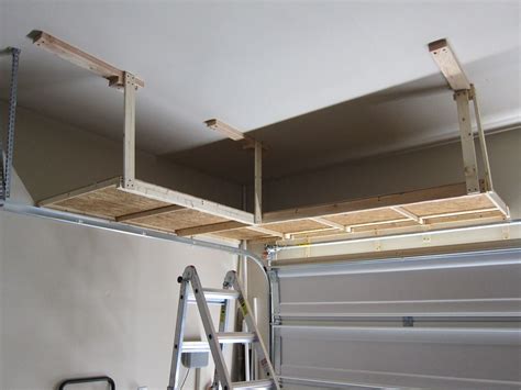 Hanging shelves above the garage door by the cavender diary Use all that space! | Hanging garage shelves, Garage ...