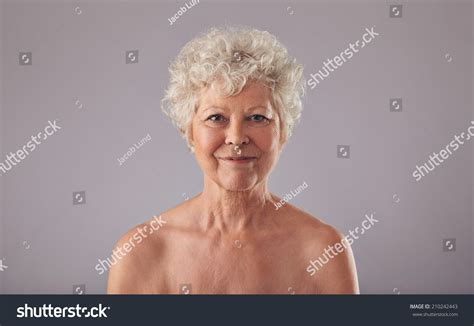 Portrait Of Beautiful Senior Woman Shirtless Against Grey Background Naked Old Woman Smiling At