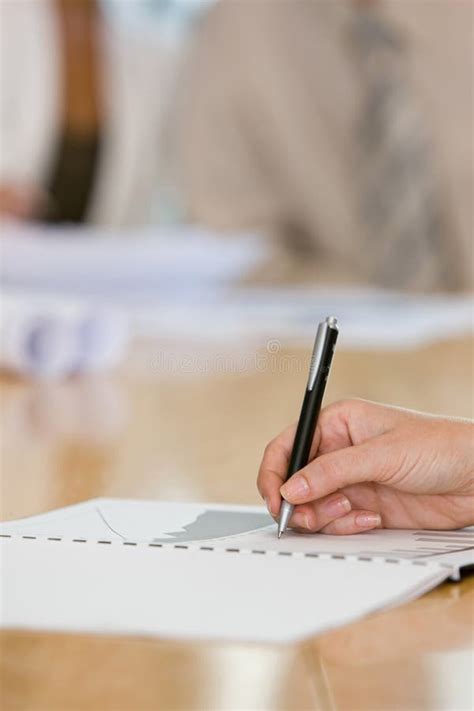 Close Shot Of A Human Hand Writing Something On The Paper Stock Photo
