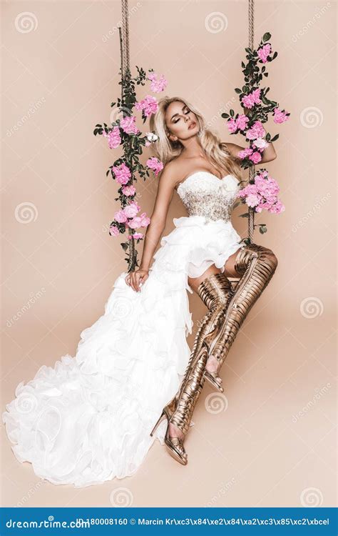 attractive blonde beauty on a flower swing spring concept beautiful natural woman in elegant