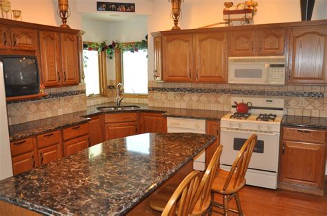 Kitchen backsplash designs are as varied as the kitchens that accommodate them. Cambria Quartz in Laneshaw compliments Oak cabinetry very ...