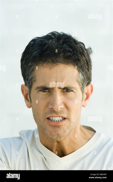 Man Scowling At Camera Head And Shoulders Portrait Stock Photo Alamy