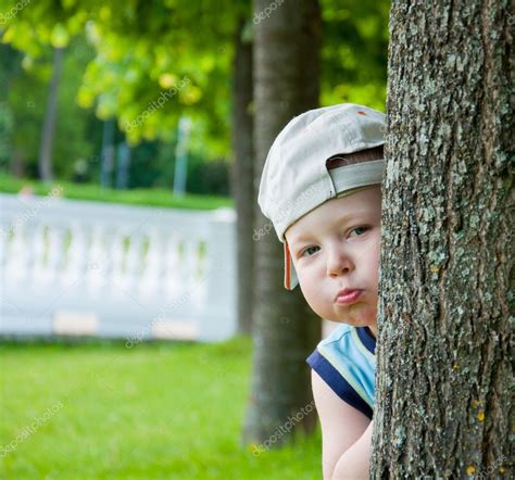 Little Boy Hiding Behind Tree Stock Photo By ©deathless 31178049